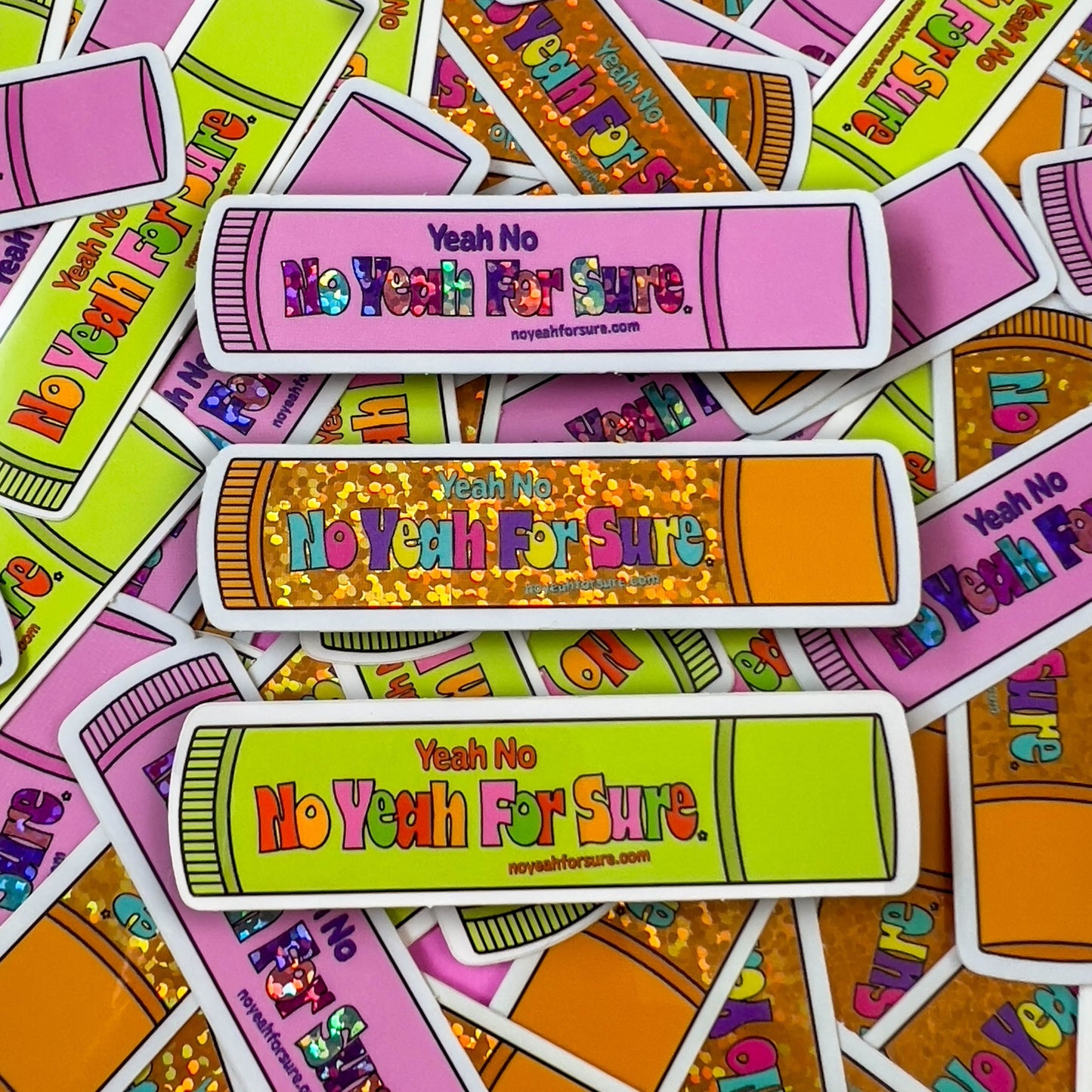 pile of pink, orange and green lip gloss stickers