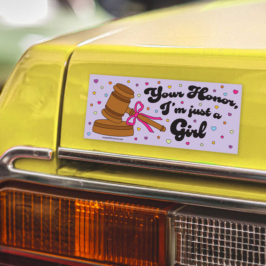 Bumper sticker with a gavel and text on a yellow car's rear bumper