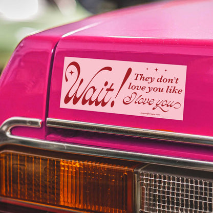 Pink car with a humorous bumper sticker on the back