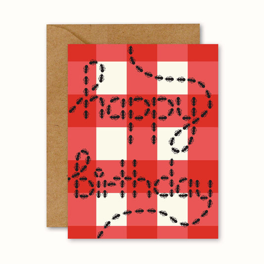 Birthday card with a red and white checker print and graphic of ants that reads "happy birthday"