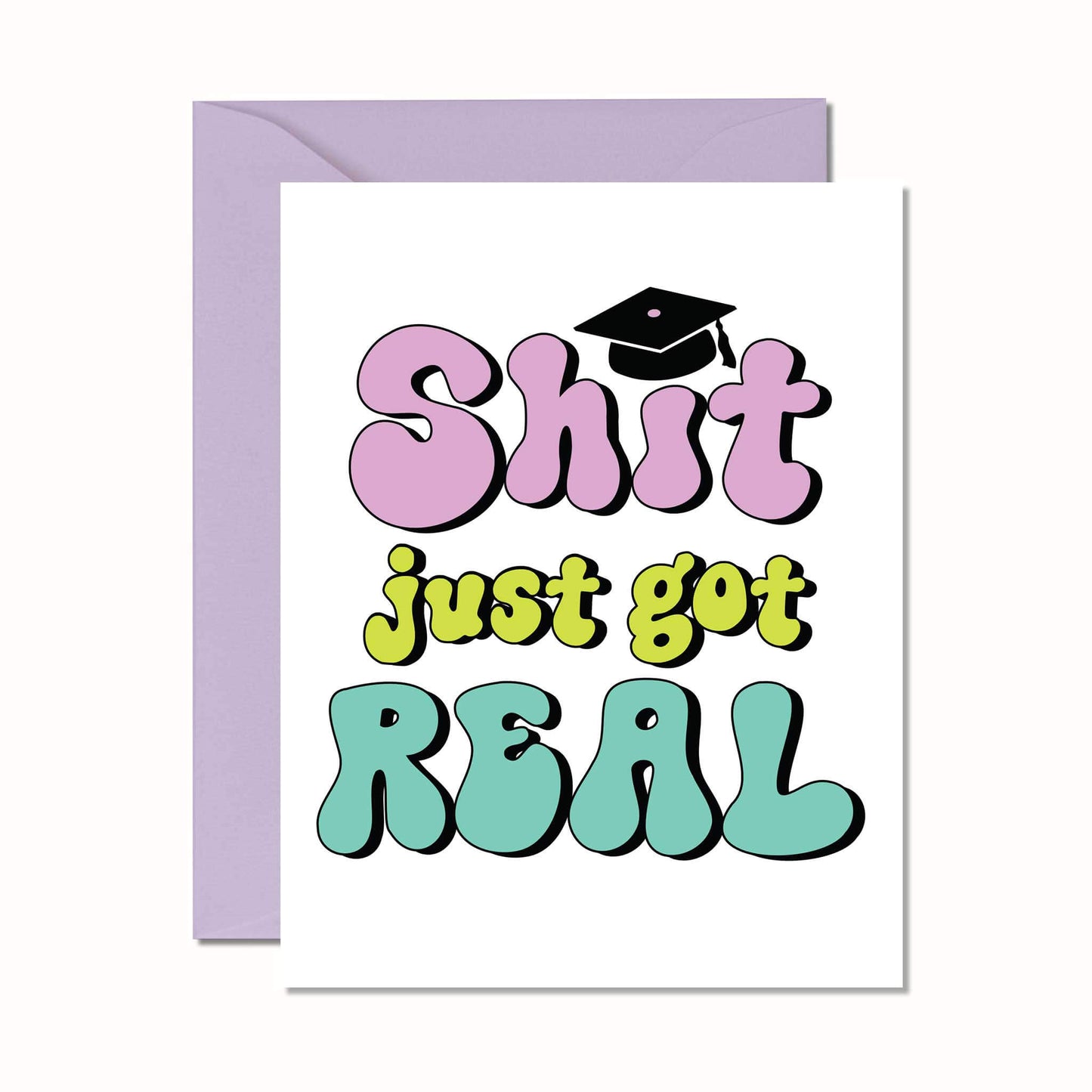 A greeting card with the phrase 'Shit just got real' designed for a graduate, featuring a colorful text layout with a graduation cap icon on the front, packaged with a purple envelope.