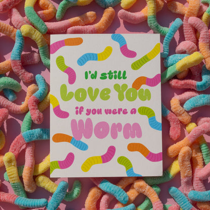 Colorful card with 'I'd still love you if you were a worm' text on a background of multicolored worms.