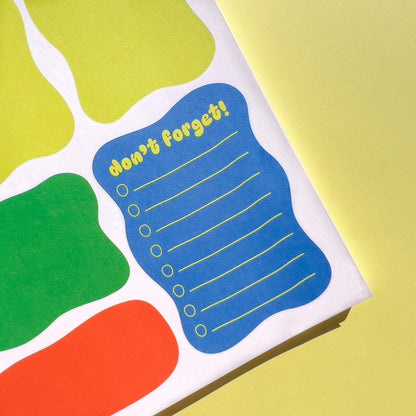 Colorful notepad with a blue section labeled 'don't forget!' on a yellow background