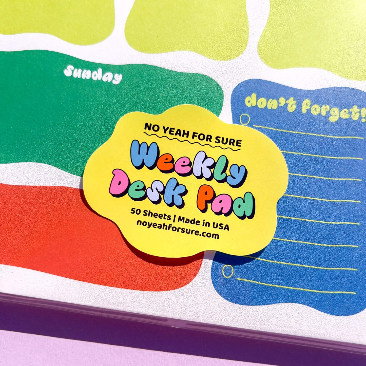 Weekly desk pad with colorful design and text on a white background