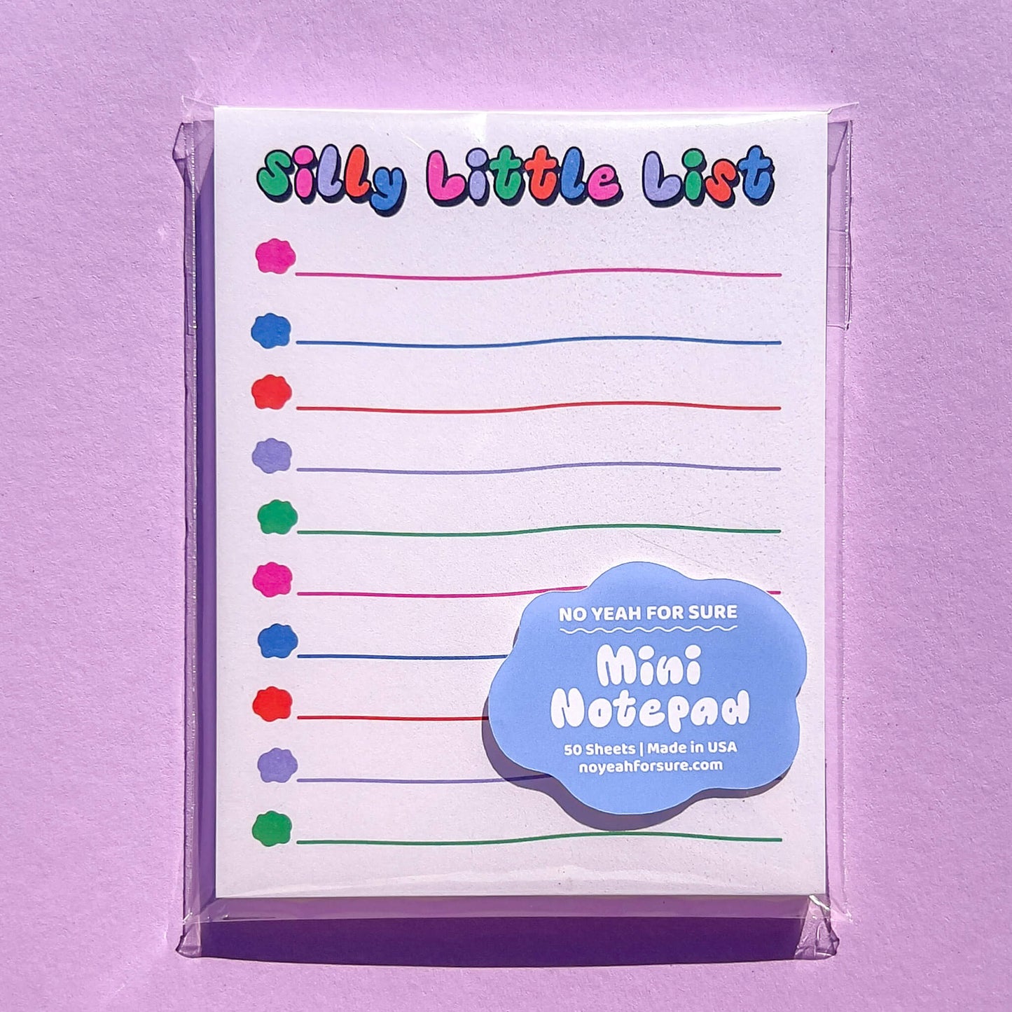 Mini notepad with colorful check boxes on a purple background