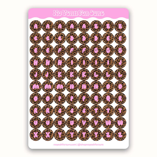 Sheet of alphabet stickers with pink letters on a leopard print background
