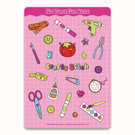 A pink craft-themed sticker sheet featuring cartoon illustrations of sewing and crafting tools, including scissors, a glue stick, a hot glue gun, a measuring tape, buttons, a needle, and a strawberry, with the text 'Crafty Bitch' on a pink grid background.
