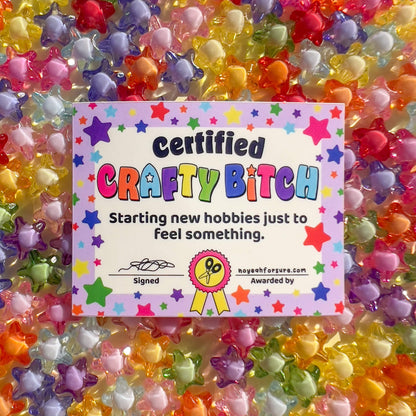 Colorful 'Certified Crafty Bitch' certificate surrounded by star-shaped beads.