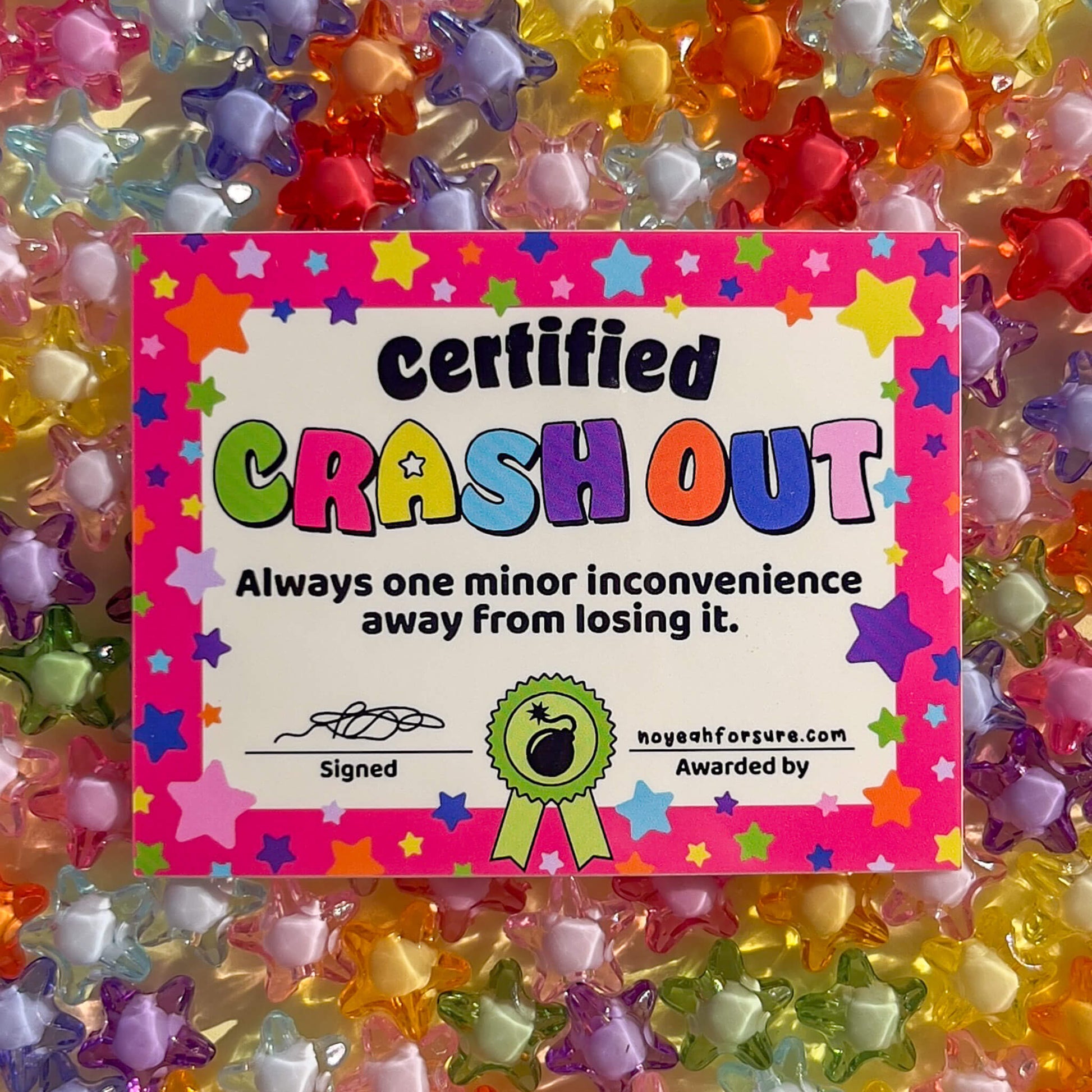 Colorful 'Certified Crash Out' certificate surrounded by star-shaped beads.