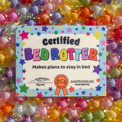Certified Bed Rotter certificate surrounded by colorful star-shaped beads