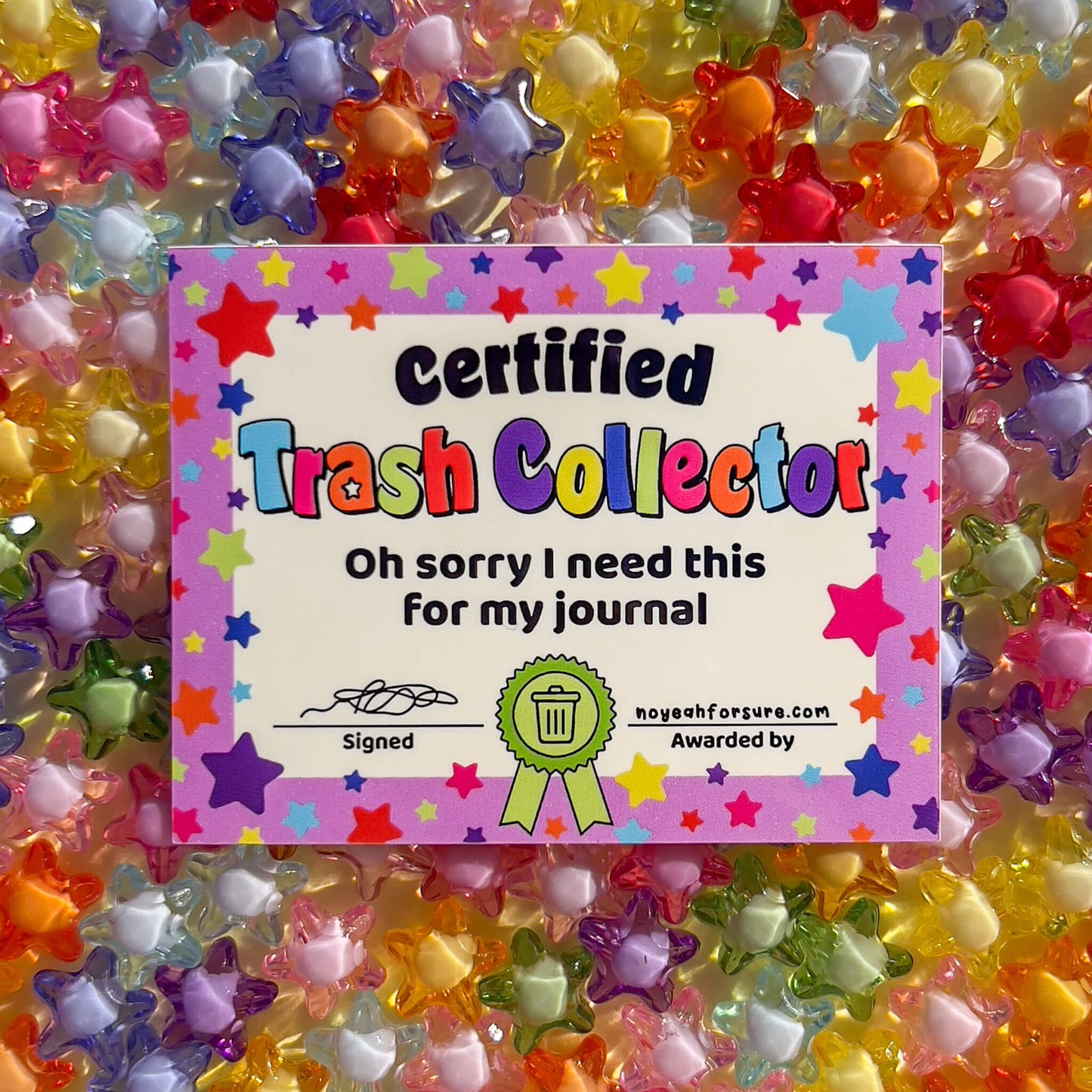 Colorful 'Certified Trash Collector' certificate surrounded by star-shaped beads.