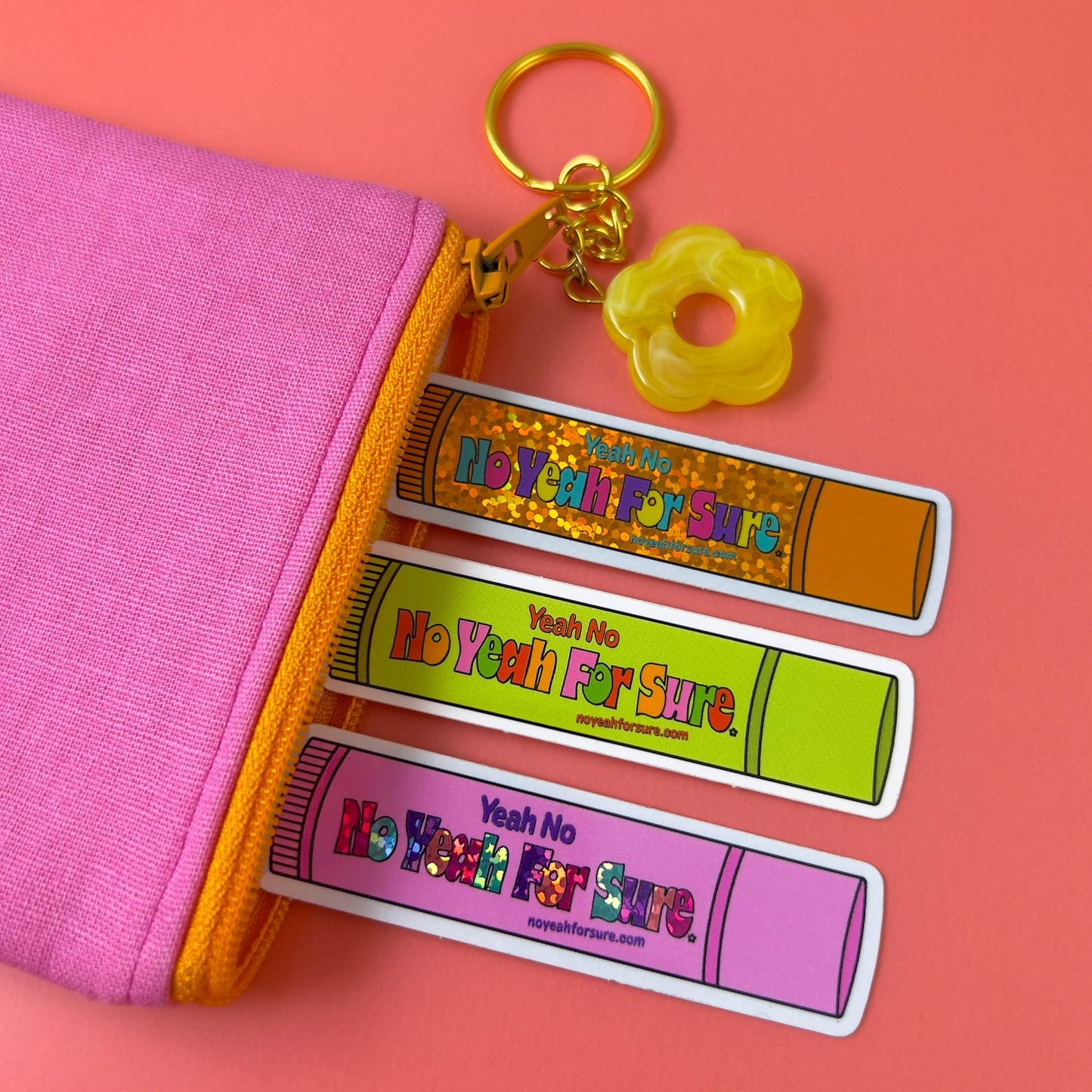 lip gloss vinyl stickers in a pink zipper coin pouch with flower keyring